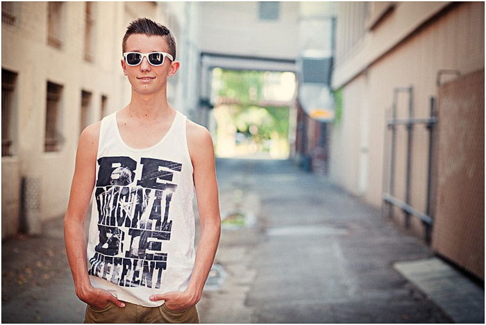 Casual senior photo of a young man posing outdoors