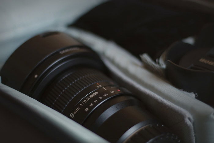 A close up of a camera lens in a camera bag - speedlight vs strobe photography