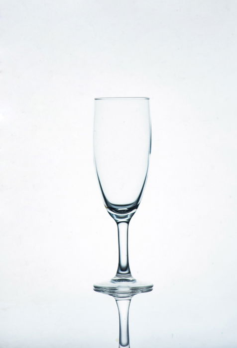 A photo of a champagne glass on white background - glass photography tips