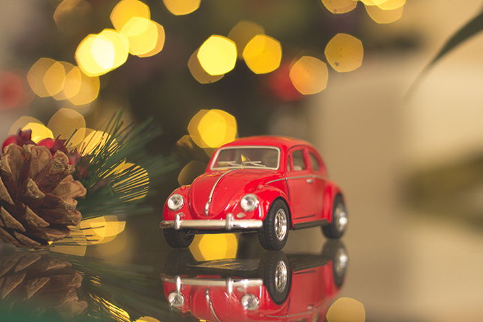 Beautiful Christmas bokeh lights in the background of a small car