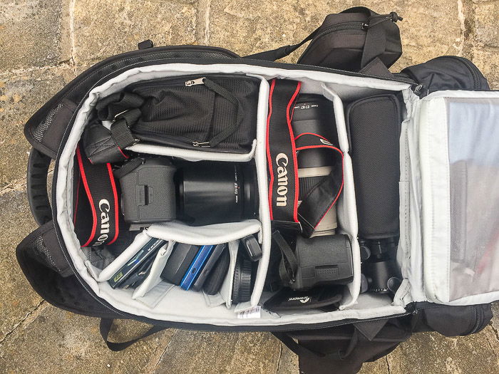 A range of stock photography equipment and accessories in a camera bag