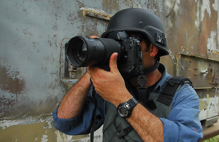 A photographer mid-shoot - stock photography equipment