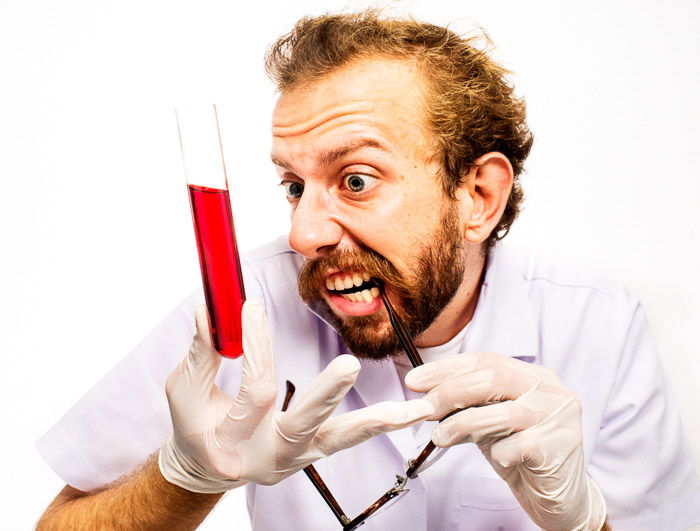 A humorous portrait of a mad scientist shot with high key lighting 