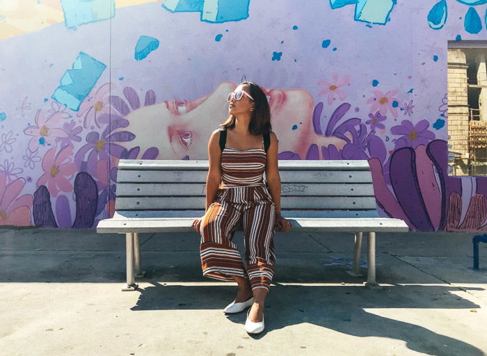 A female model posing on a bench taken with an iphone photo timer