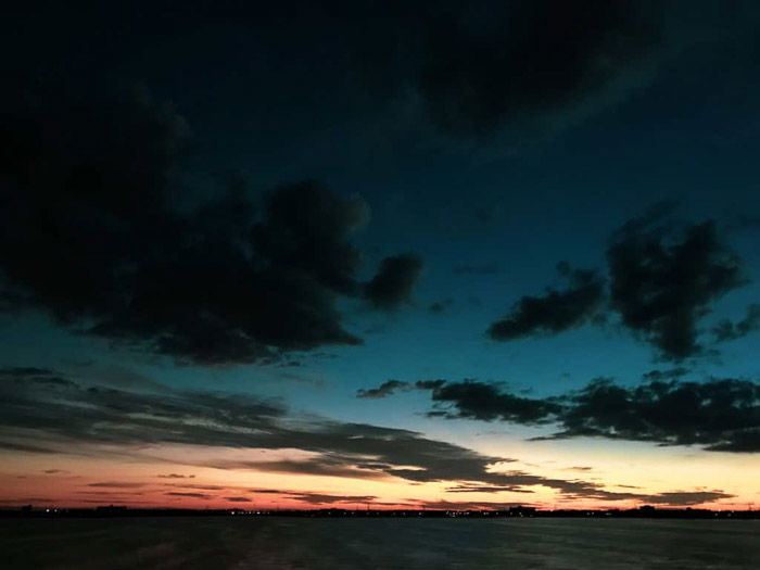 Incredible iphone night photography of a cloudy sky taken at blue hour