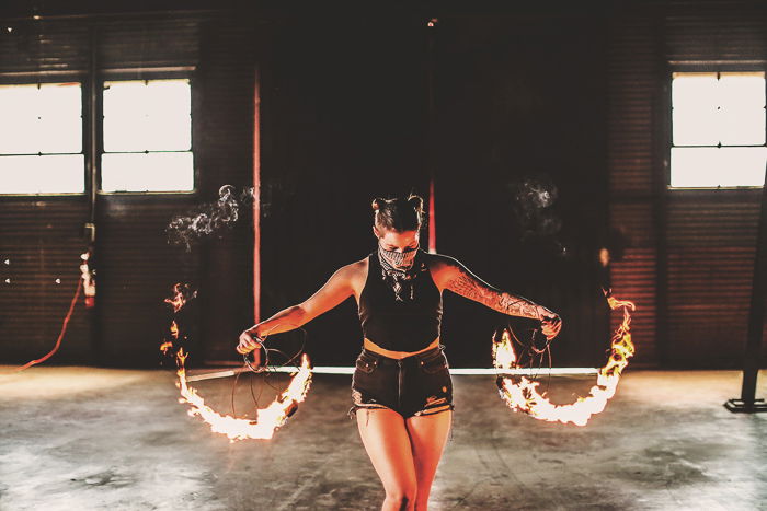 A portrait of a female fire dancer