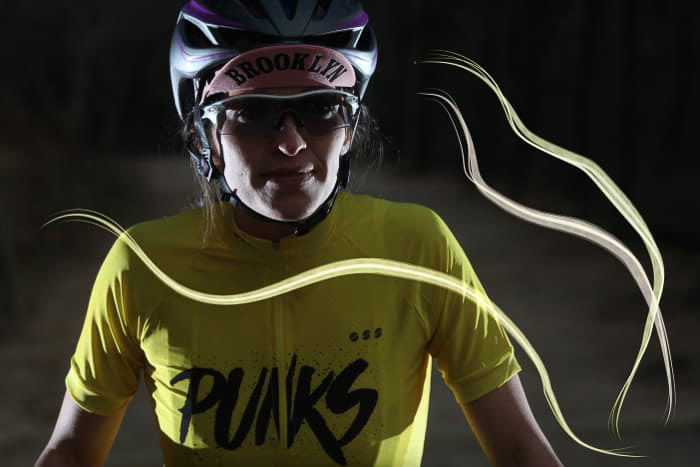 A portrait of a female athlete in low light with Photoshop Lighting effects overlayed