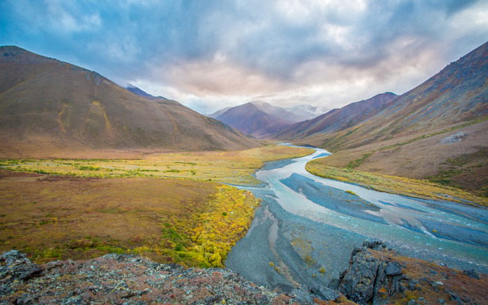 A stunning autumn photography landscape shot of mountains and a river