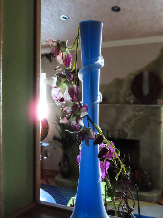 An indoor shot of a purple flowered plant in a blue vase, taken with canon powershot sx740 hs