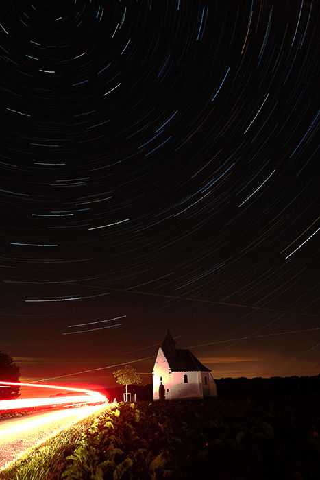 Foinal image of a night landscape with stunning star trails