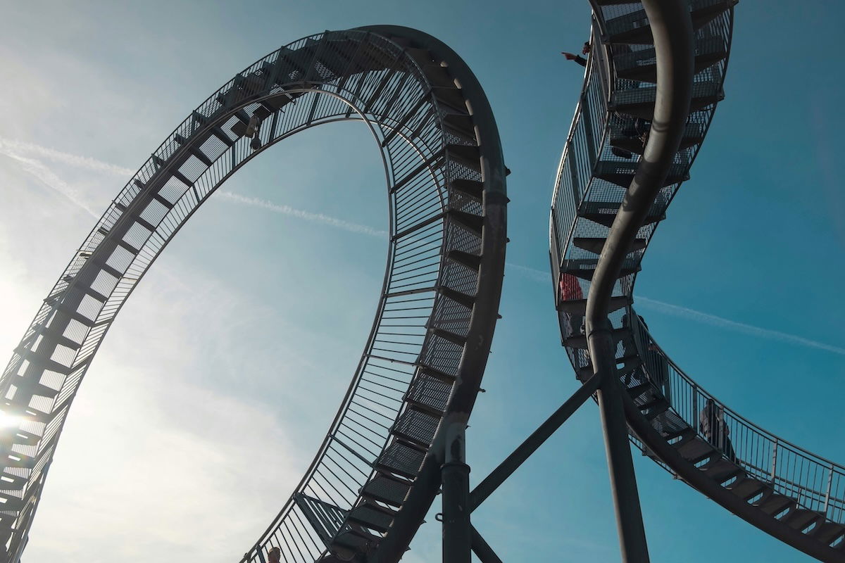 Parts of an amusement part ride against the sky showing an imbalanced imaged