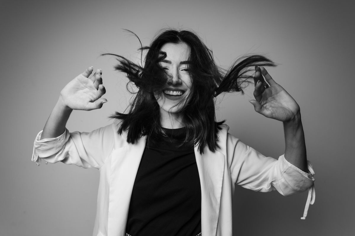 A black-and-white photo of a woman flicking her hair showing balance in photography