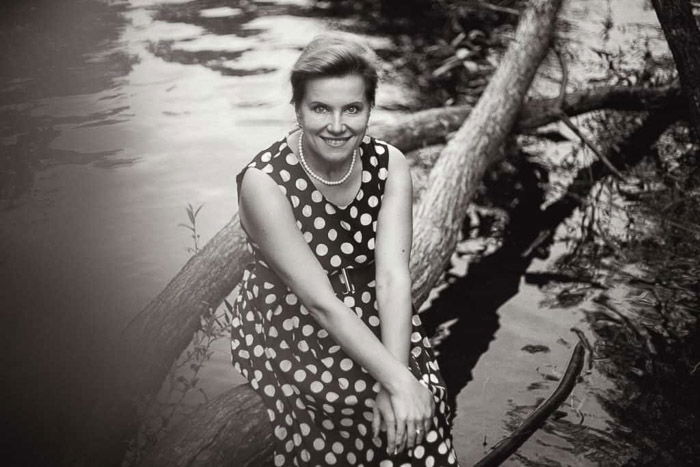 A black and white photography portrait of a woman in a polka dot dress