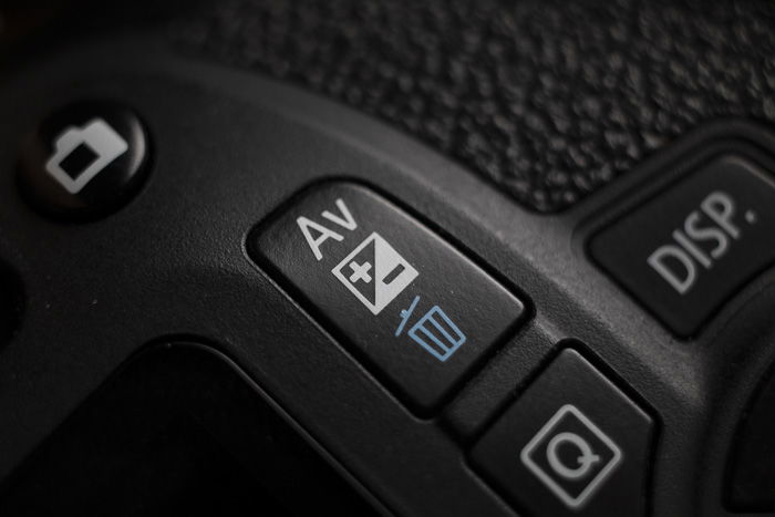 Exposure compensation button on a Canon 1300D