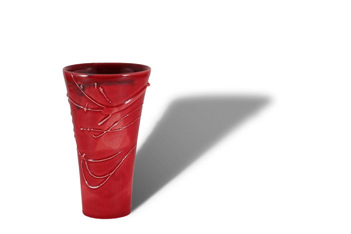 A product photography shot of a red vase with a strong shadow