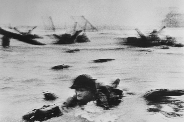 Robert Capa famous photos of D-day, Normandy. Omaha Beach. The first wave of American troops lands at dawn.