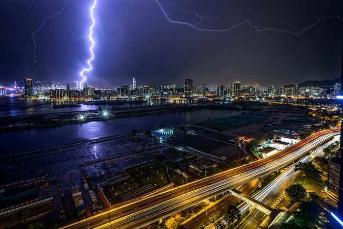 Forked lighting striking over a city at night