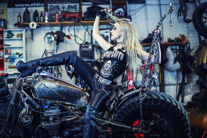 Cool motorcycle photography portrait of a female model posing on a bike