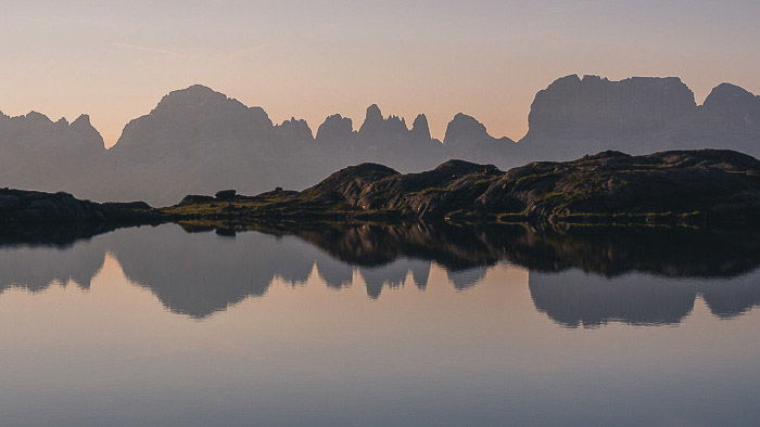 A stunning mountainous landscape over Dolomiti di Brenta relected in the lake below - reflections in photography