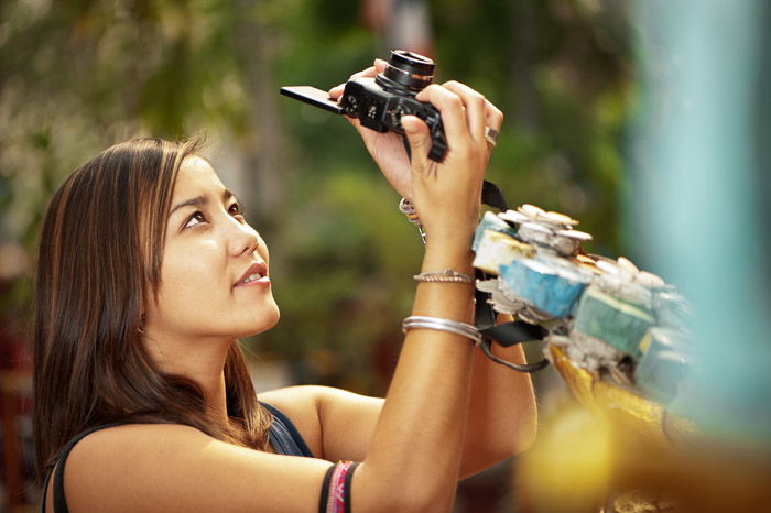 A female photographer taking a photo with a rim light