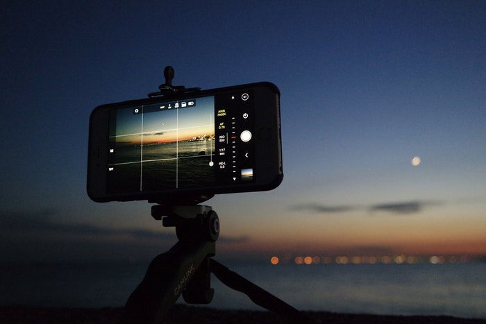 An iPhone on a tripod taking a night time photo 