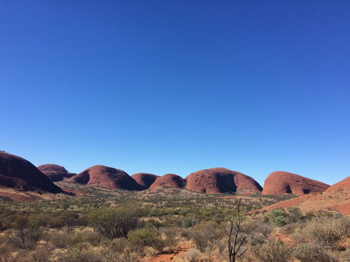 desert landscape and rolling hills against a clear blue sky