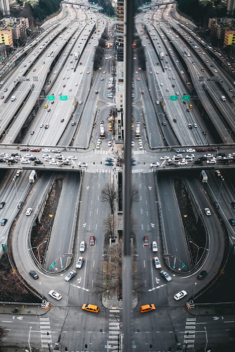 Aerial photo of a sprawling highway reflected in a building 