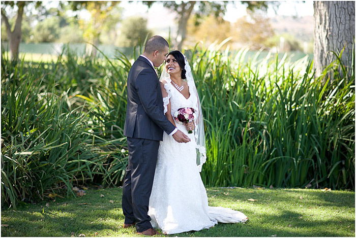 Destination wedding photo of the newlywed couple posing outdoors