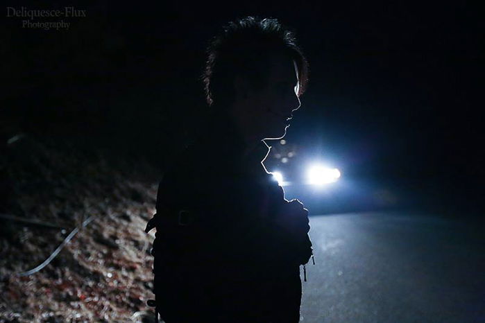 A male model posing for an atmospheric night portrait photography shot