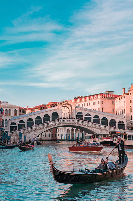 A beautiful shot of a gondola in a canal in venice - best cities to visit in europe