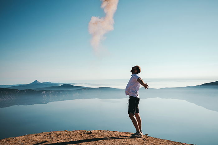 A candid portrait of a man in front of a stunning landscape