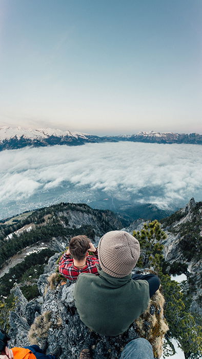 A candid wide angle shot of friends hiking through a mountainous landscape 