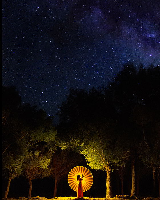 Atmospheric dance photographer of a female dancer in a forest at night