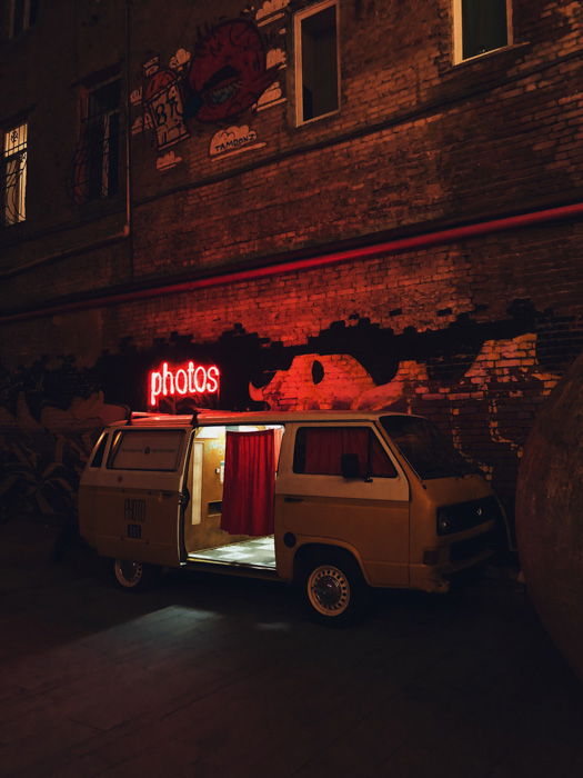 A photo booth set up in a van at night