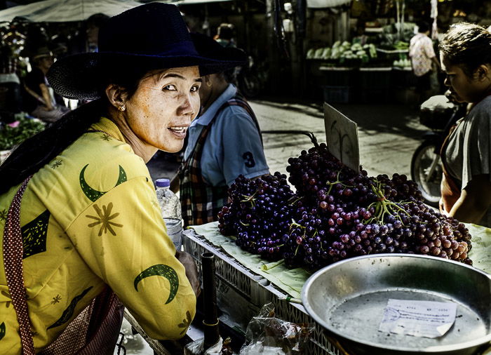 A street portrait of a market vendor