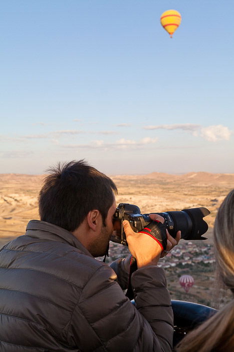 A close up portrait of a photographer taking hot air balloon photos