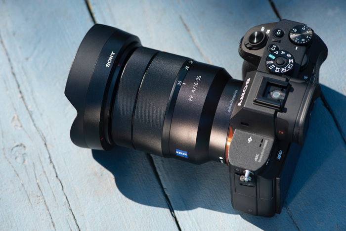 A DSLR camera resting on a blue table 