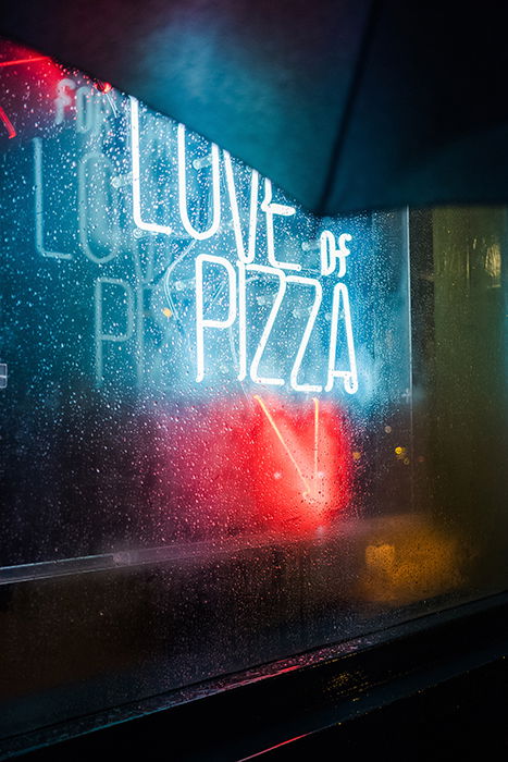 Neon signs shot through a rainy window