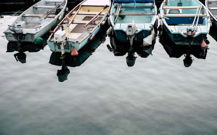 Four boats parked in a harbour 