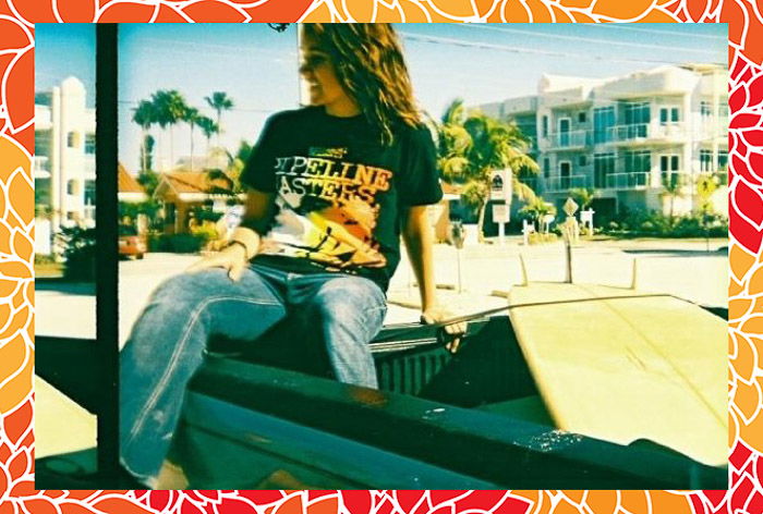 A portrait of a girl posing on the back of a convertible car, with an orange patterned Photoshop frame 