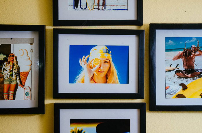 Photos prints displayed in frames on a wall