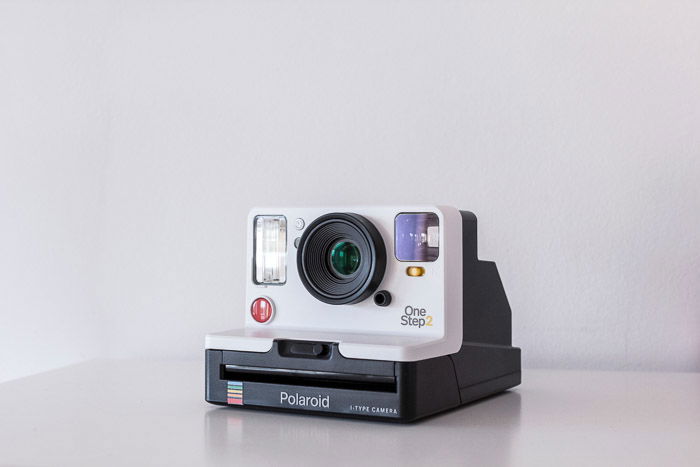 A product photography shot of a polaroid camera on white background