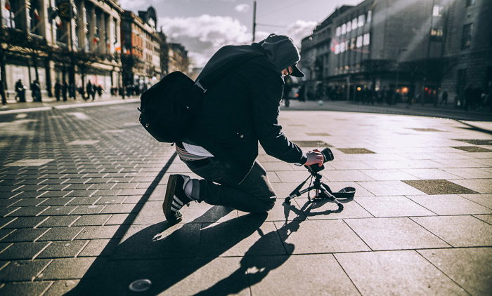 A photographer shooting product photography with a tripod