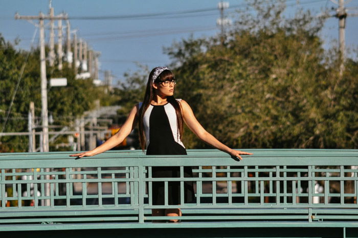 A portrait of a female model posing on a bridge shot with a telephoto lens