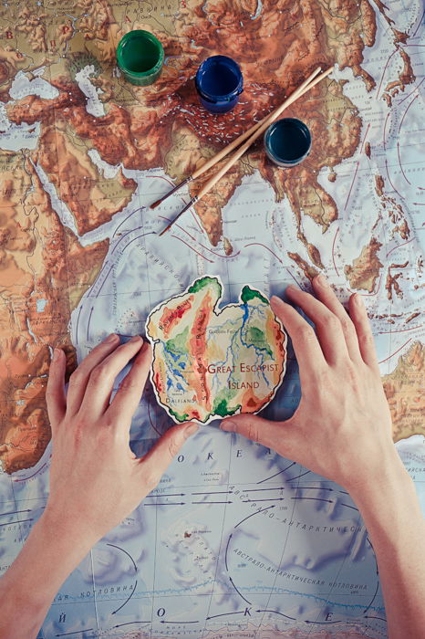 A creative image of a person painting a map of a world - examples of using text in photography