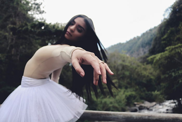 A beautiful ballet photography shot of a female dancer posing outdoors