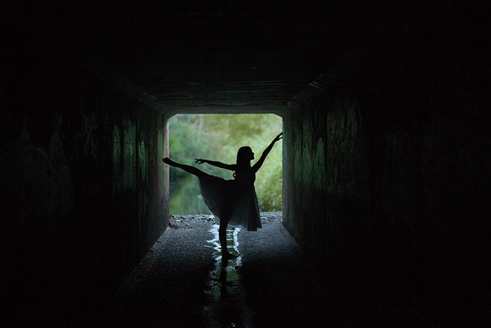 A beautiful ballet photography shot of a female dancer posing outdoors