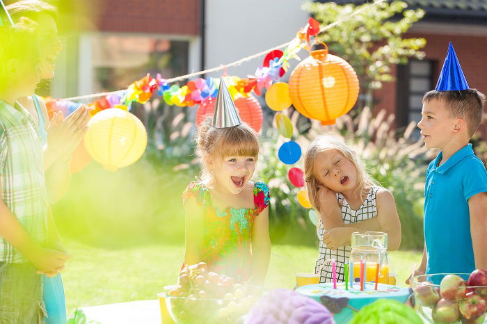 Happy children with party hats having fun on a birthday party