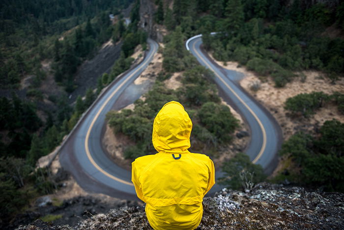 A conceptual photo of a person sitting above a highway