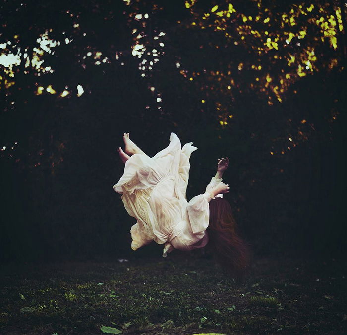 Surreal portrait of a female model falling outdoors by fine art photographer Gina Vasquez